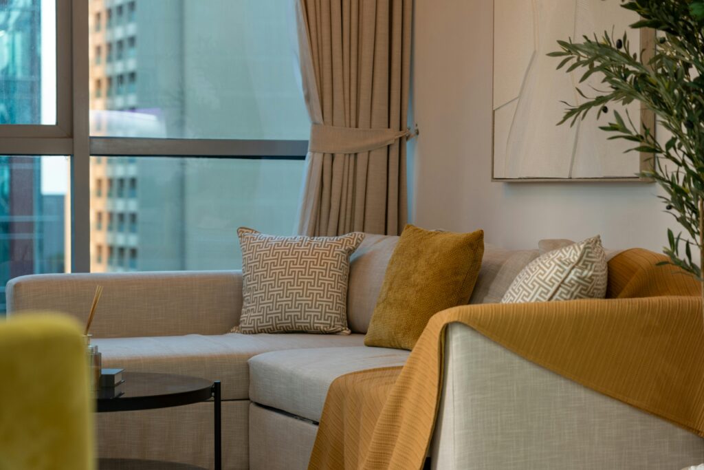 Home Elegant modern living room in Dubai featuring a cozy sofa and stylish decor.